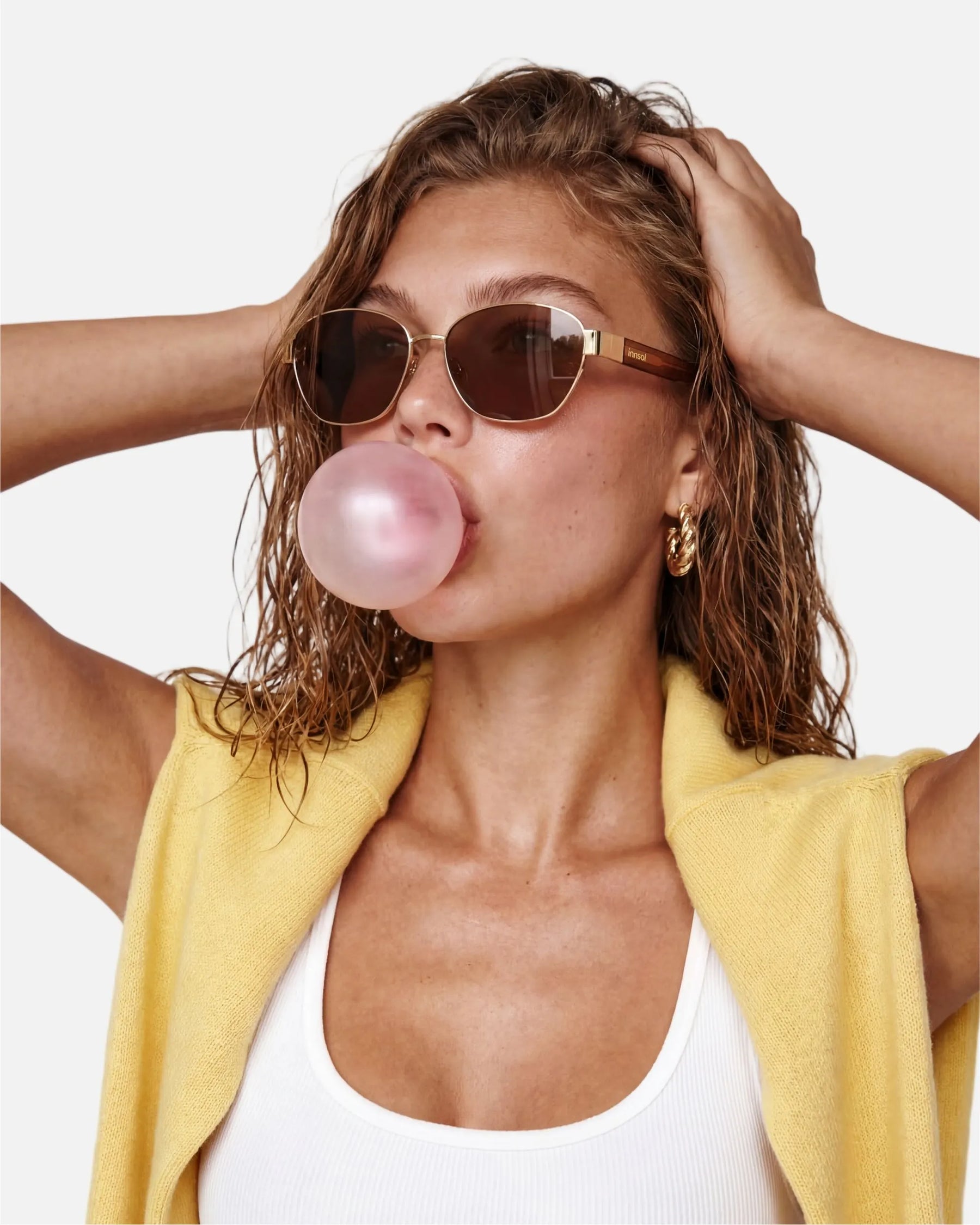 Model wearing innsol Bate Y2K oval cat eye metal sunglasses for vacation outfits, festival styling, selfies, and elevated everyday looks