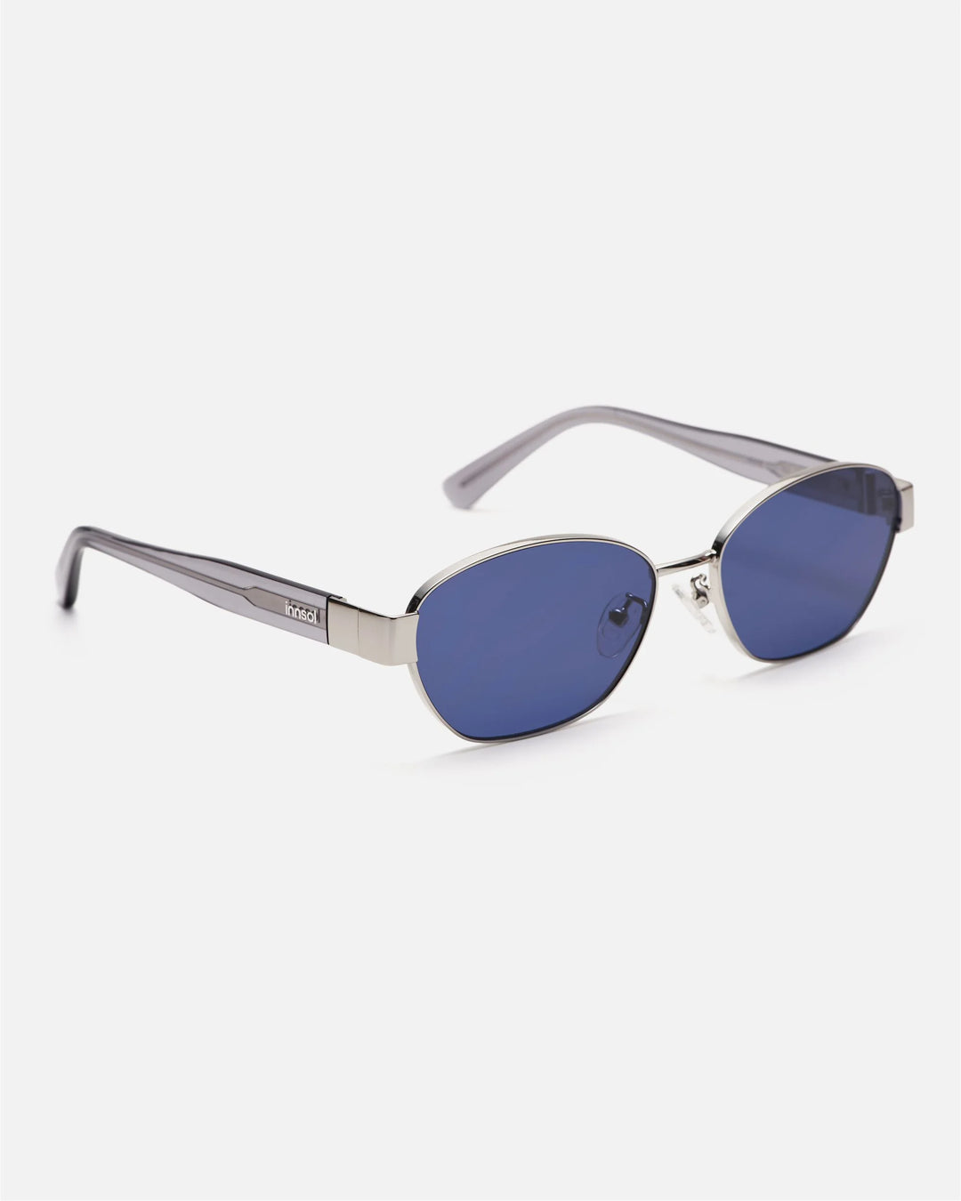 Side view of innsol Bate sunglasses showing silver metal frame and tinted dark blue lenses