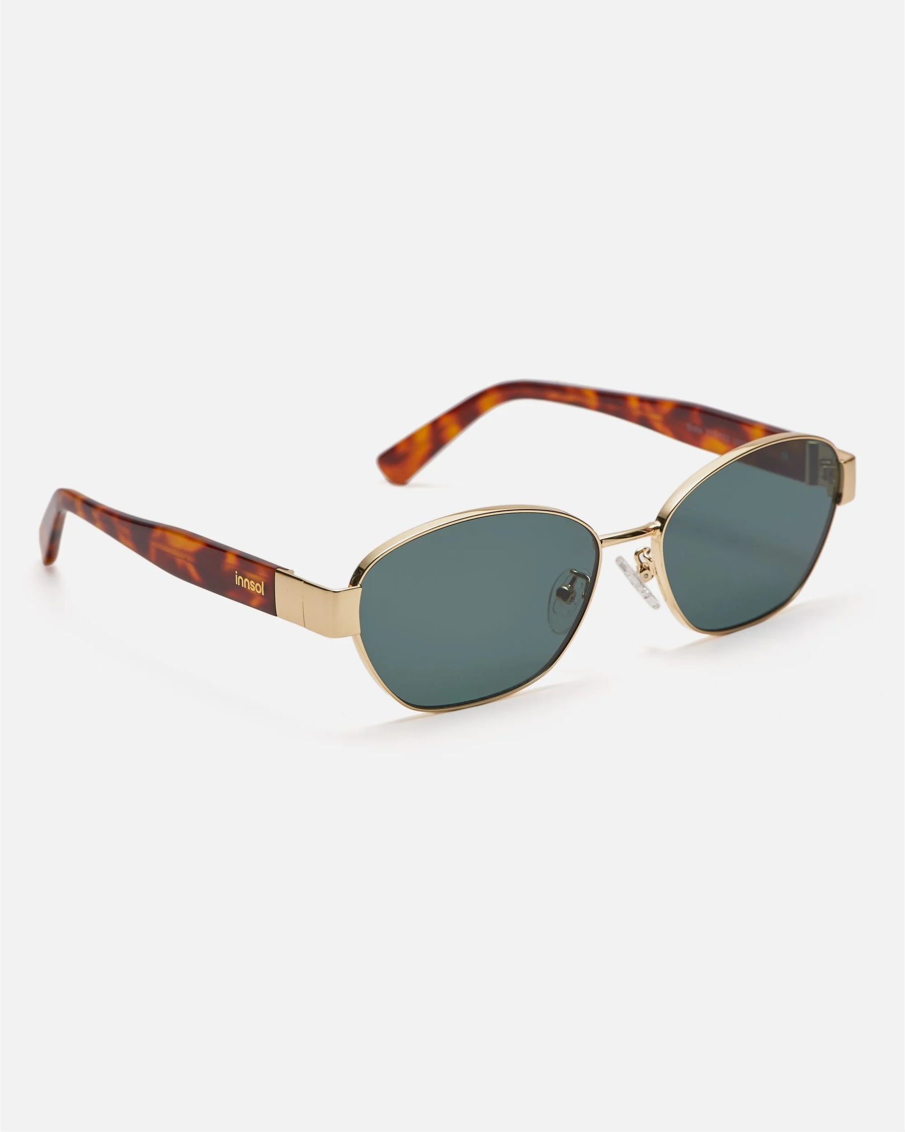 Side view of innsol Bate sunglasses showing gold metal frame and green lenses