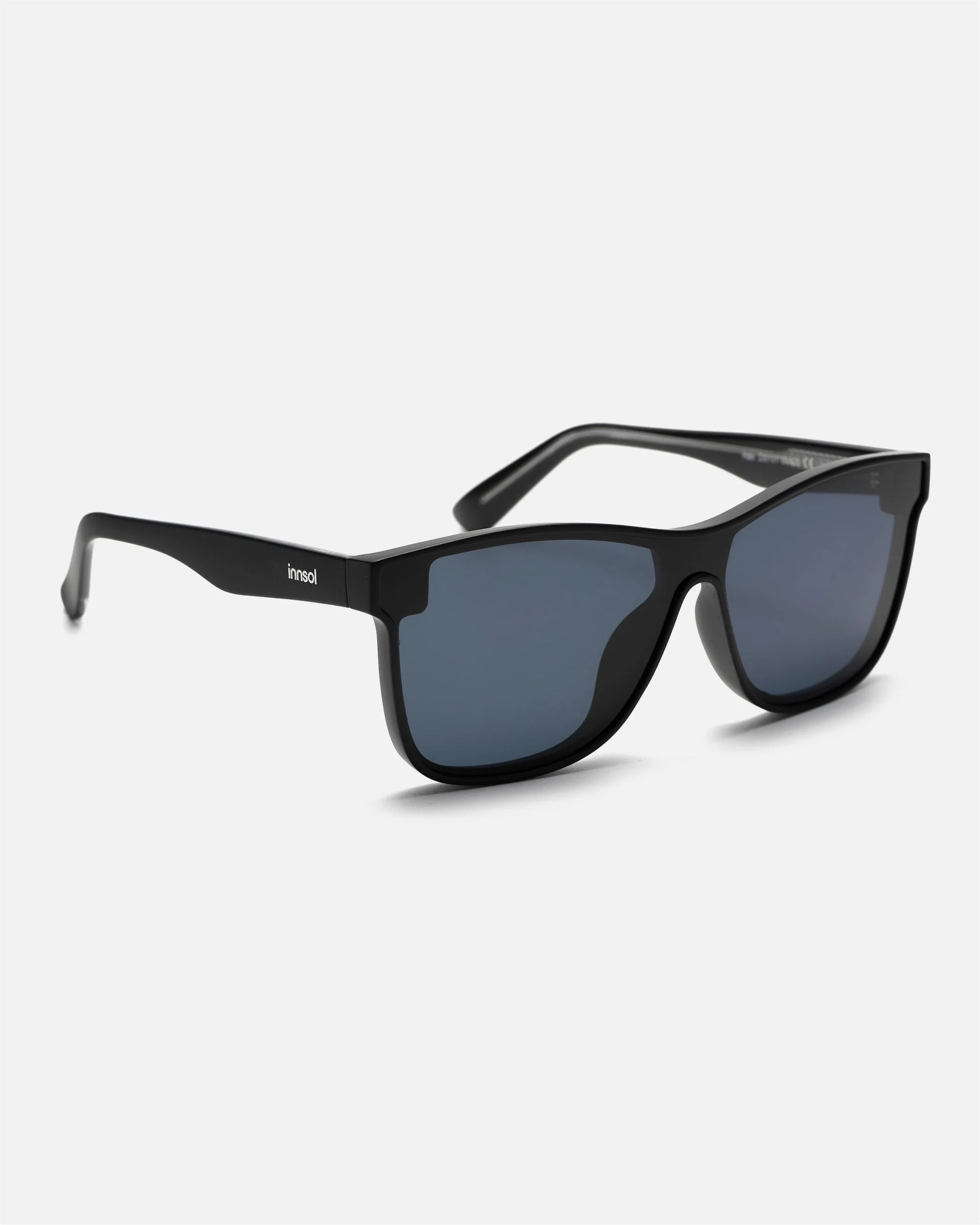 Side view of innsol Halo sunglasses showing matte black lightweight frame and gray lenses