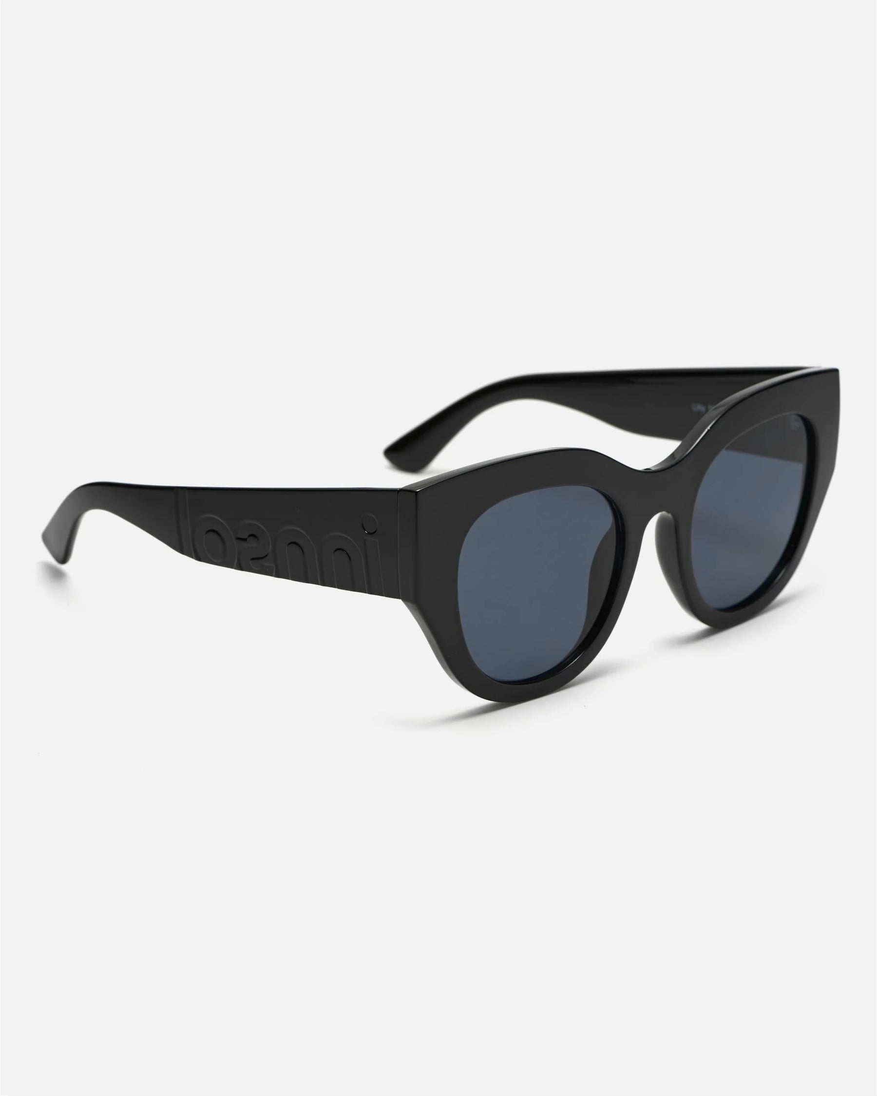 Side view of innsol Lilly sunglasses showing gloss black lightweight frame and gray lenses