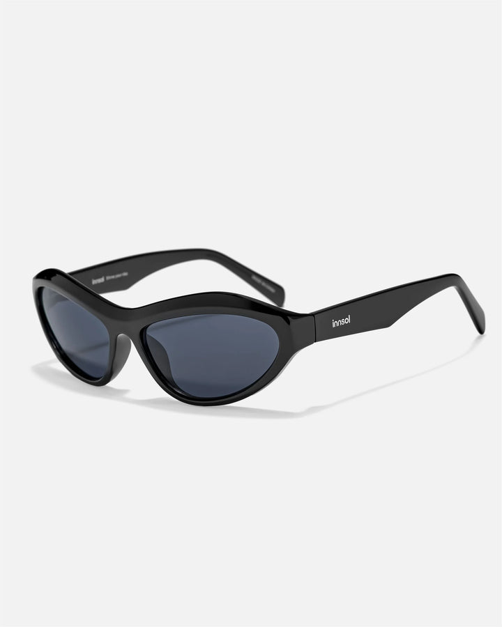 Alternate side angle of innsol Motion sunglasses featuring wraparound frame, upswept profile, and Y2K streetwear shape in gloss black