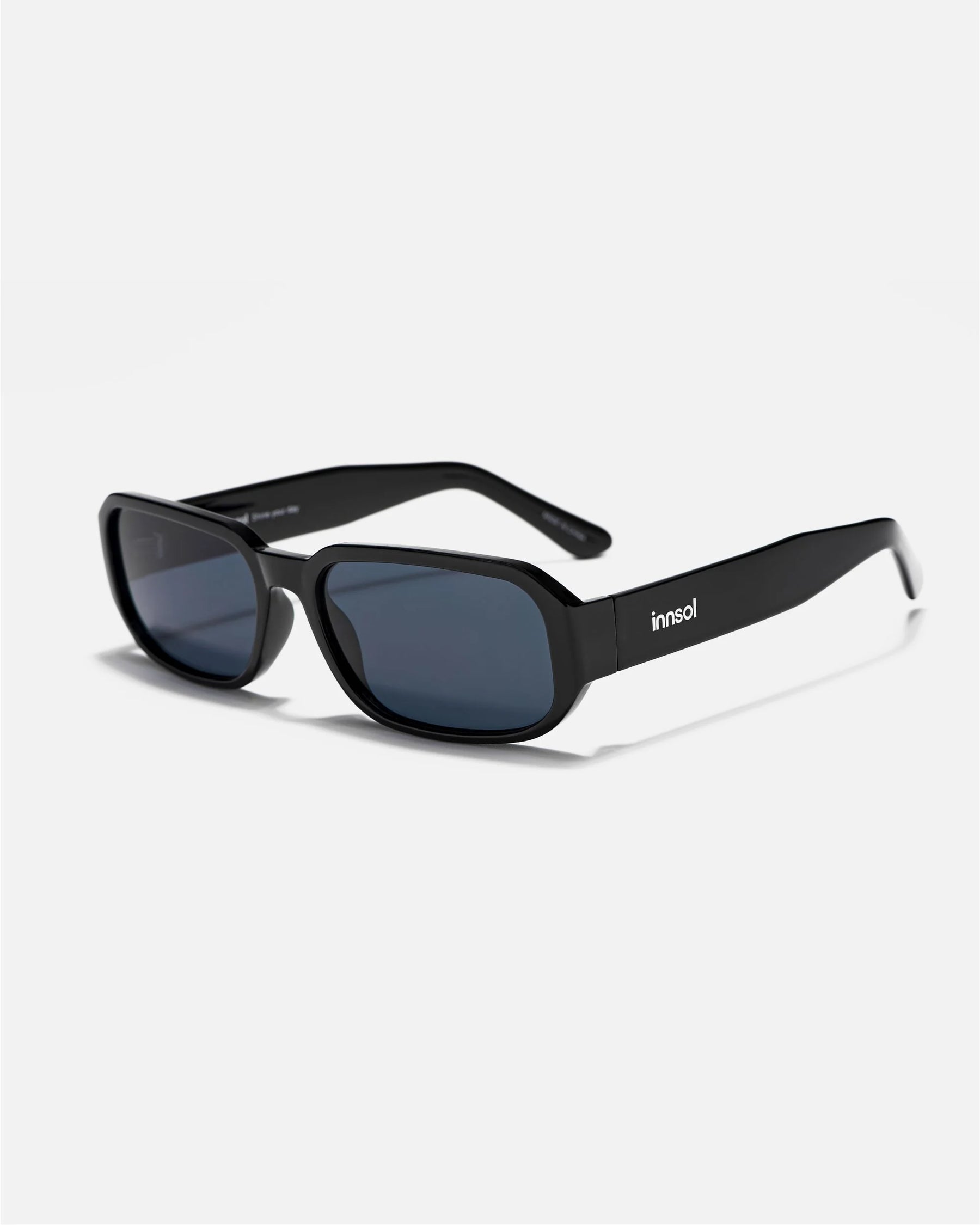 Alternate side angle of innsol Romeo sunglasses featuring small rectangular frame, slim temples, and clean minimalist profile in gloss black