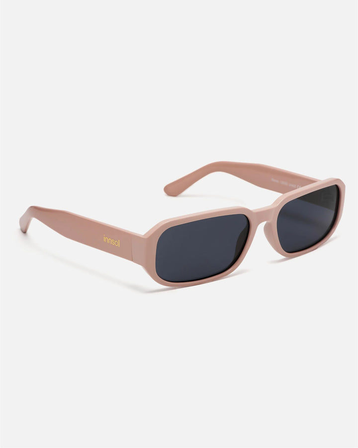 Side view of innsol Romeo sunglasses showing gloss solid pink lightweight frame and gray lenses