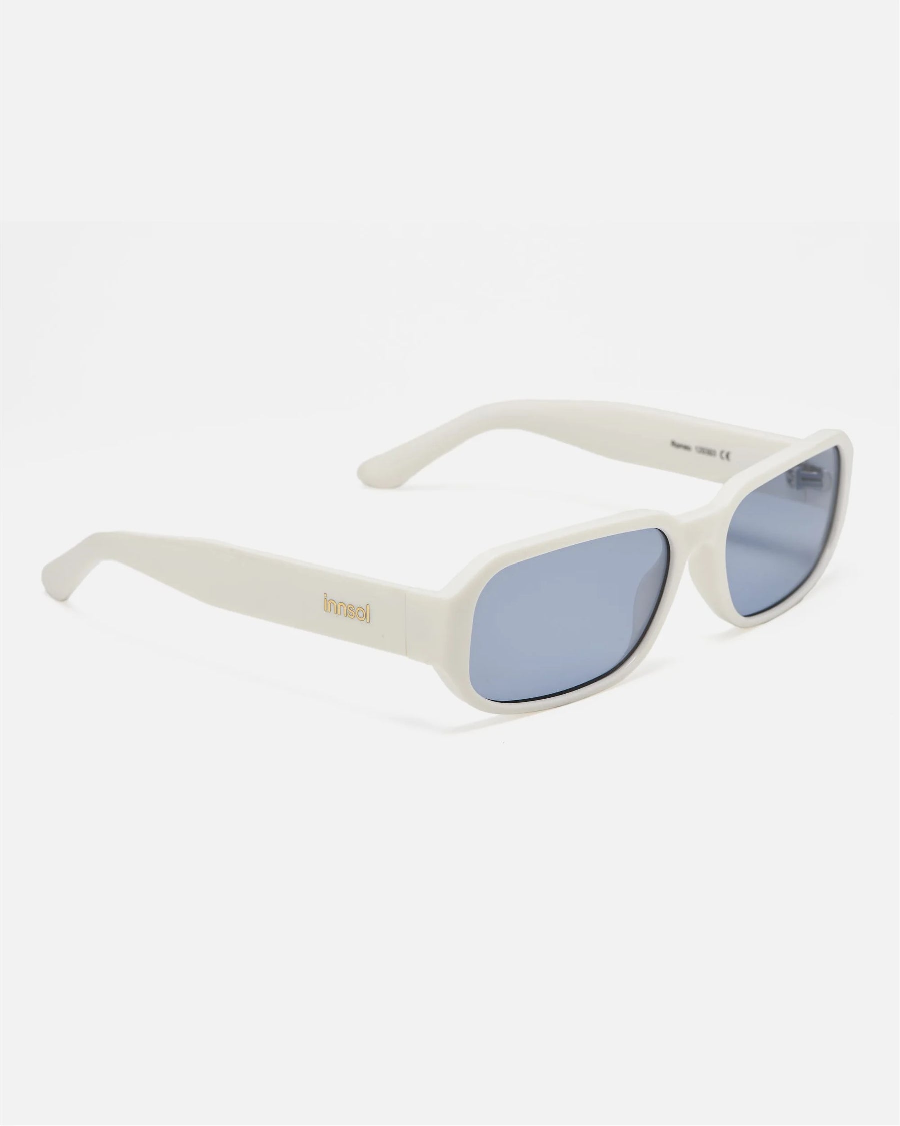 Side view of innsol Romeo sunglasses showing gloss white lightweight frame and tinted light blue lenses