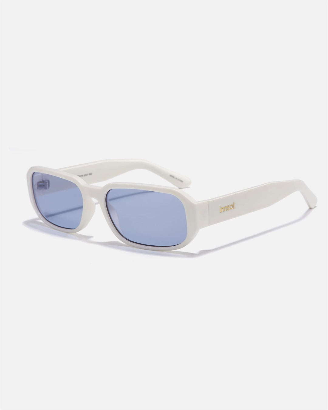 Alternate side angle of innsol Romeo sunglasses featuring small rectangular frame, slim temples, and clean minimalist profile in gloss white