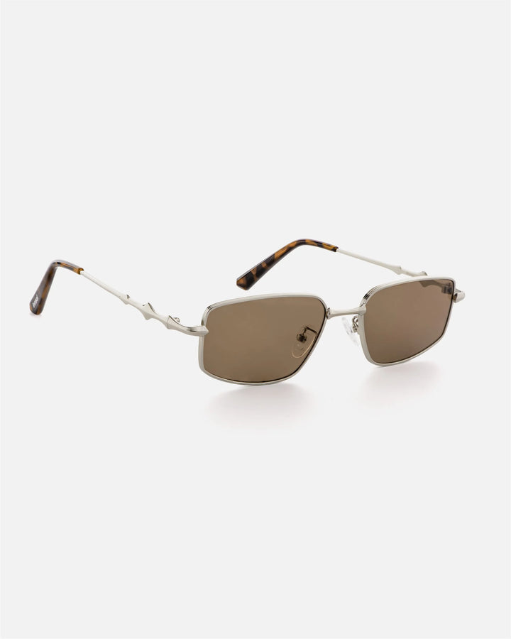 Side view of innsol Skyway sunglasses showing silver metal frame and brown lenses