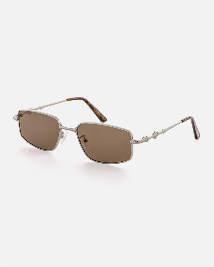 Alternate side angle of innsol Skyway sunglasses featuring polished metal bridge, sculptural temples, and tortoiseshell temple tips in silver