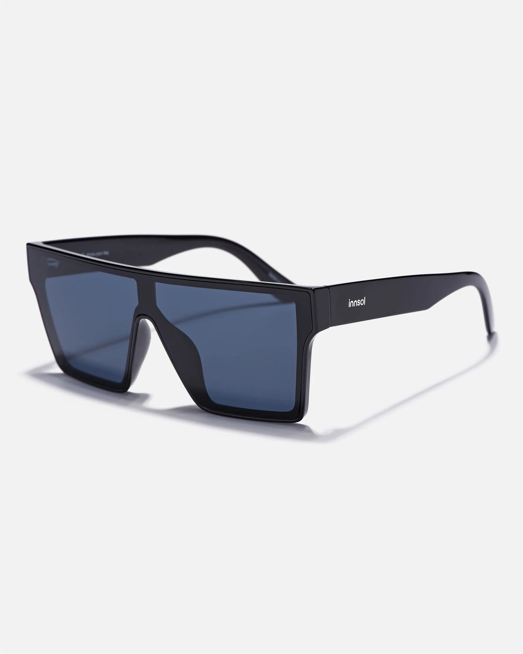 Alternate side angle of innsol Sydney sunglasses featuring oversized shield visor lens and smooth frame in gloss black