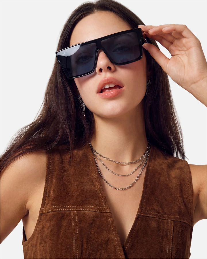 Model wearing innsol Sydney oversized one-piece shield visor sunglasses for festivals, pool days, street photography, and high-energy social content