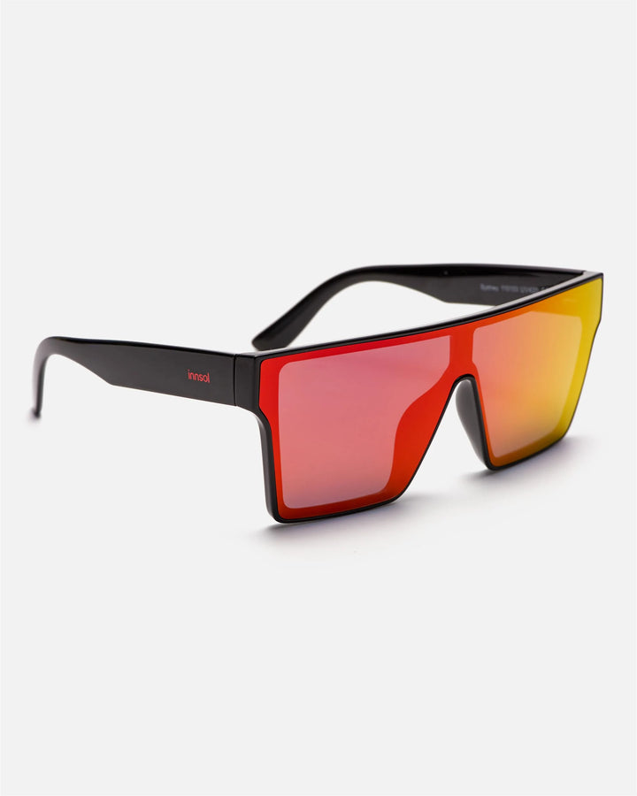 Side view of innsol Sydney sunglasses showing gloss black lightweight frame and red mirrored lenses
