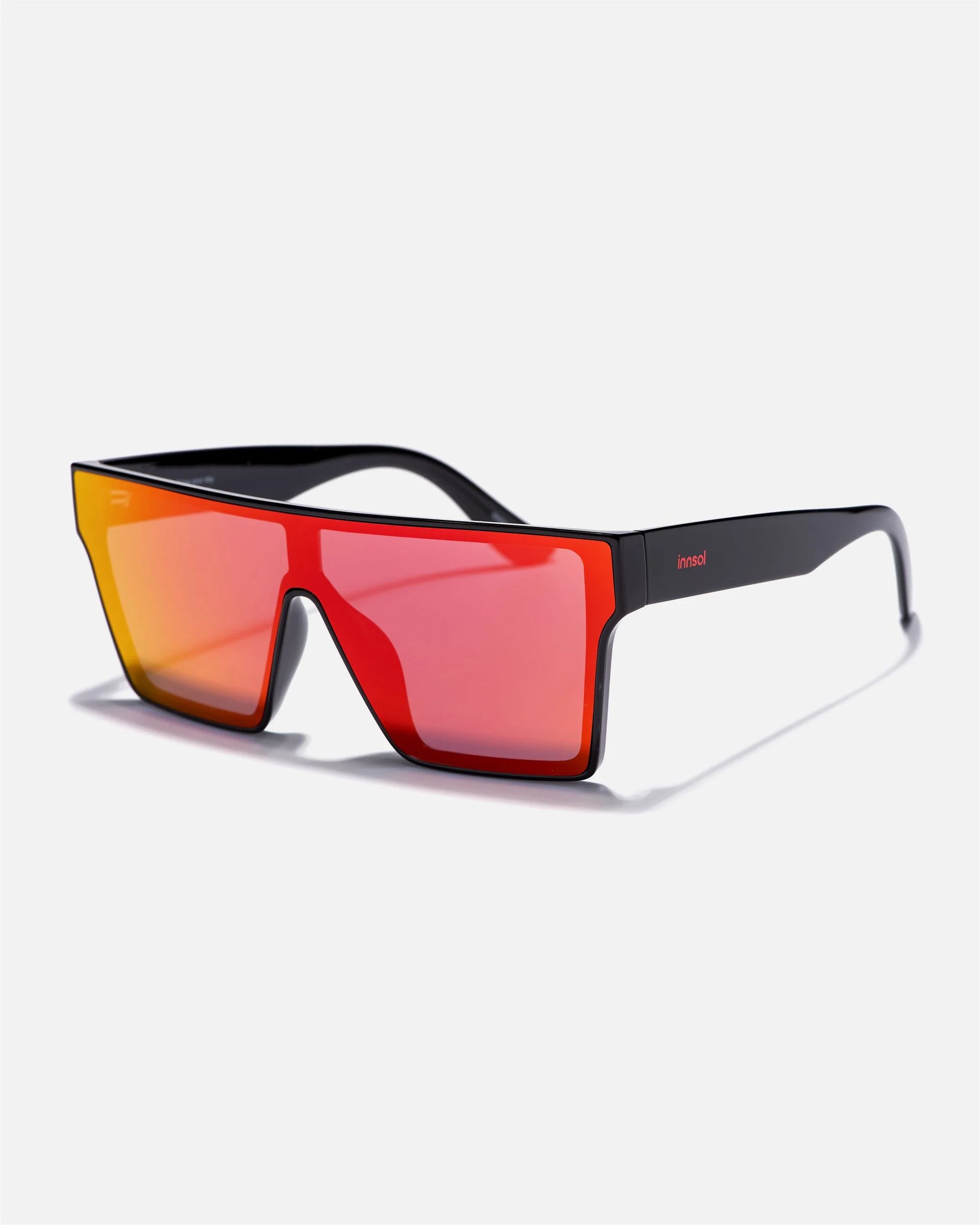 Alternate side angle of innsol Sydney sunglasses featuring oversized shield visor lens and smooth frame in gloss black