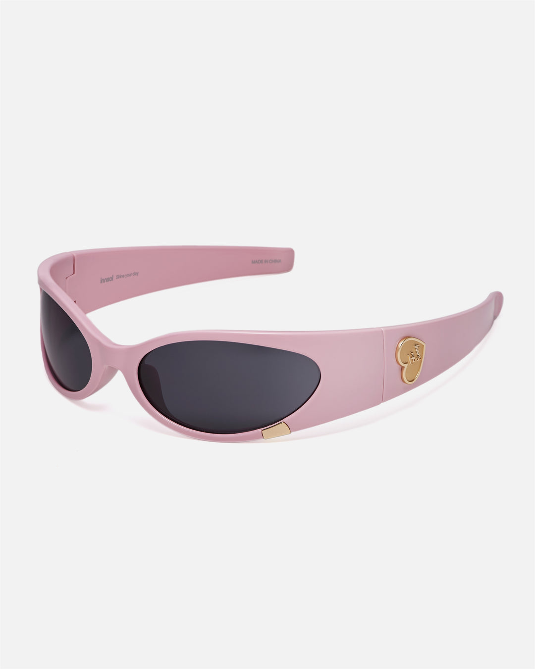 Angled view of innsol Cail Solid Pink sunglasses with gray lenses