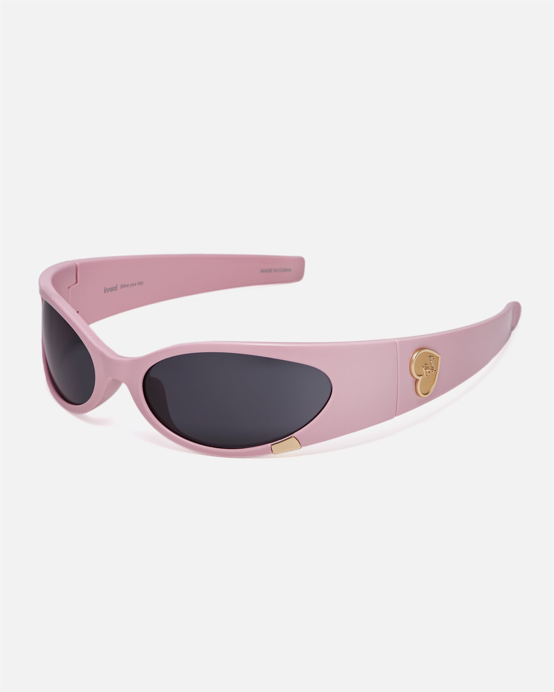 Angled view of innsol Cail Solid Pink sunglasses with gray lenses